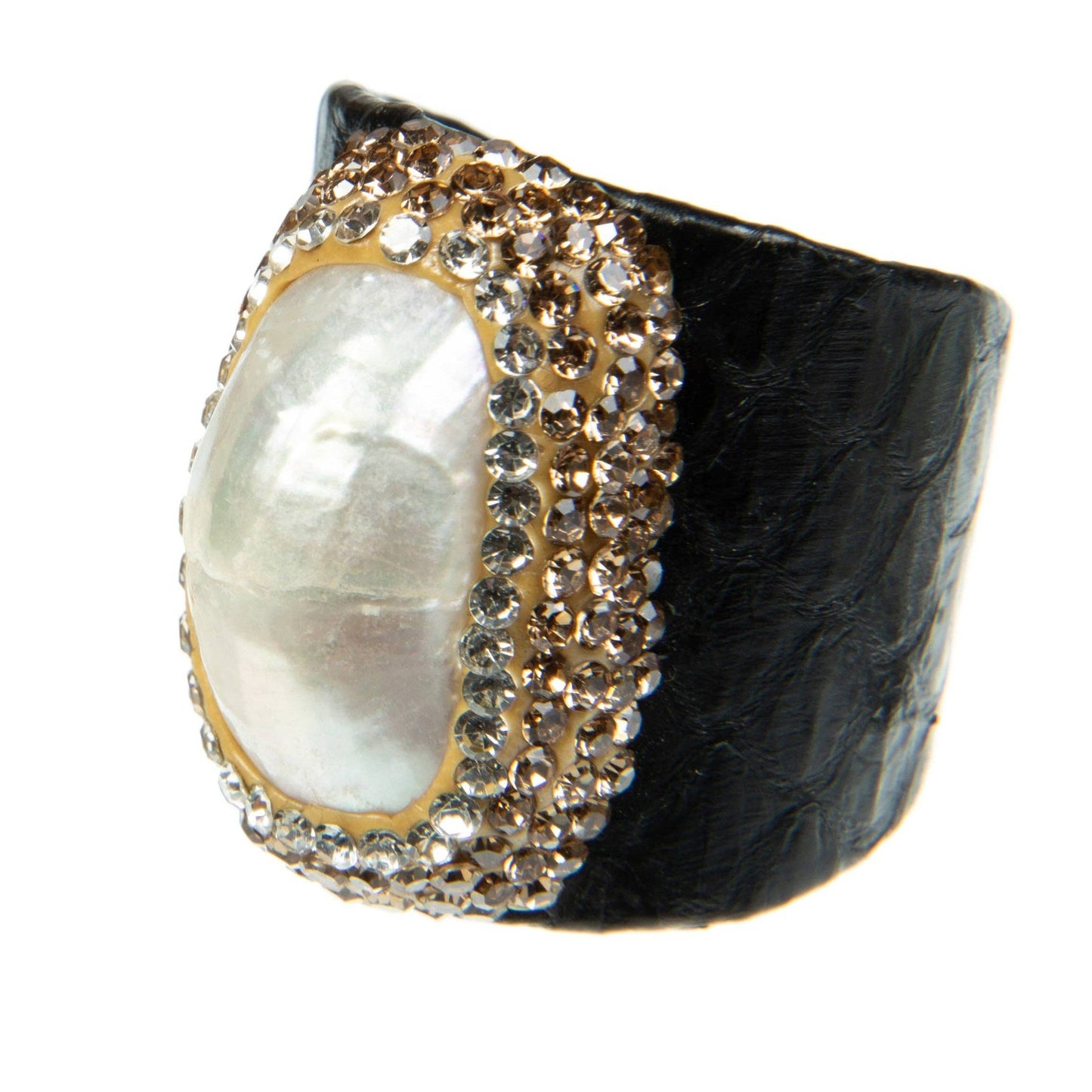 Ring with black band, pearl center, and gold and silver accents on a white background