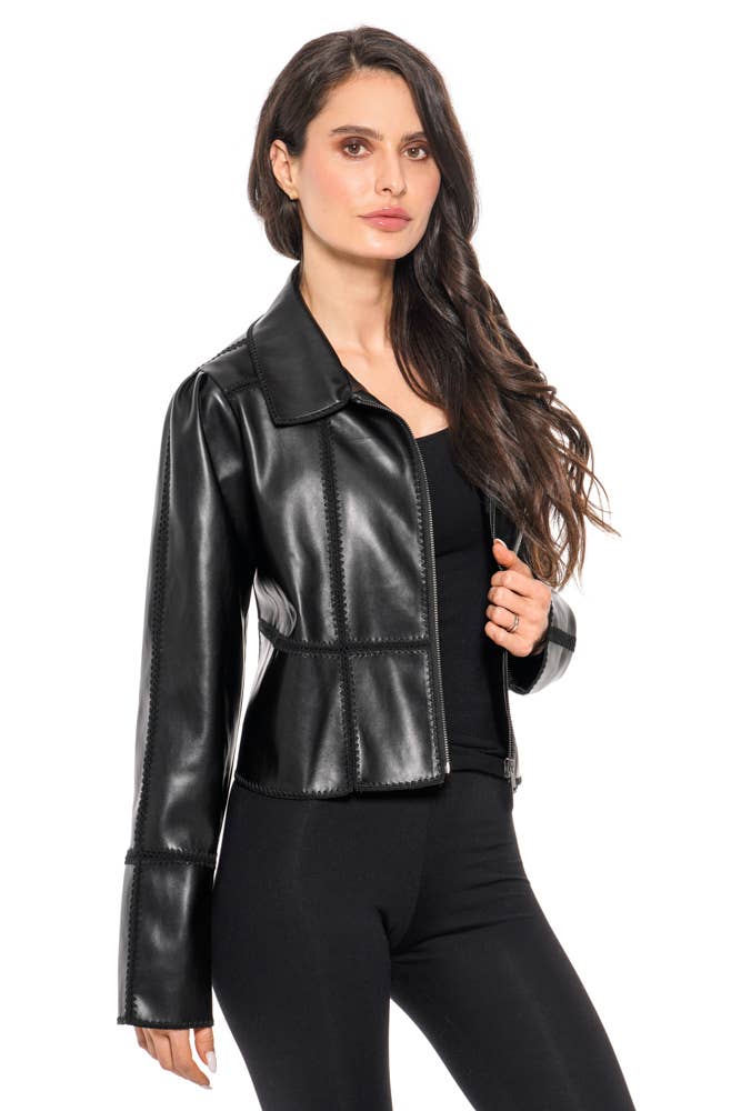 Woman wearing a black leather jacket on a white background