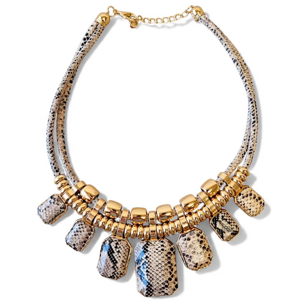 Necklace with gold and patterned beads on a white background
