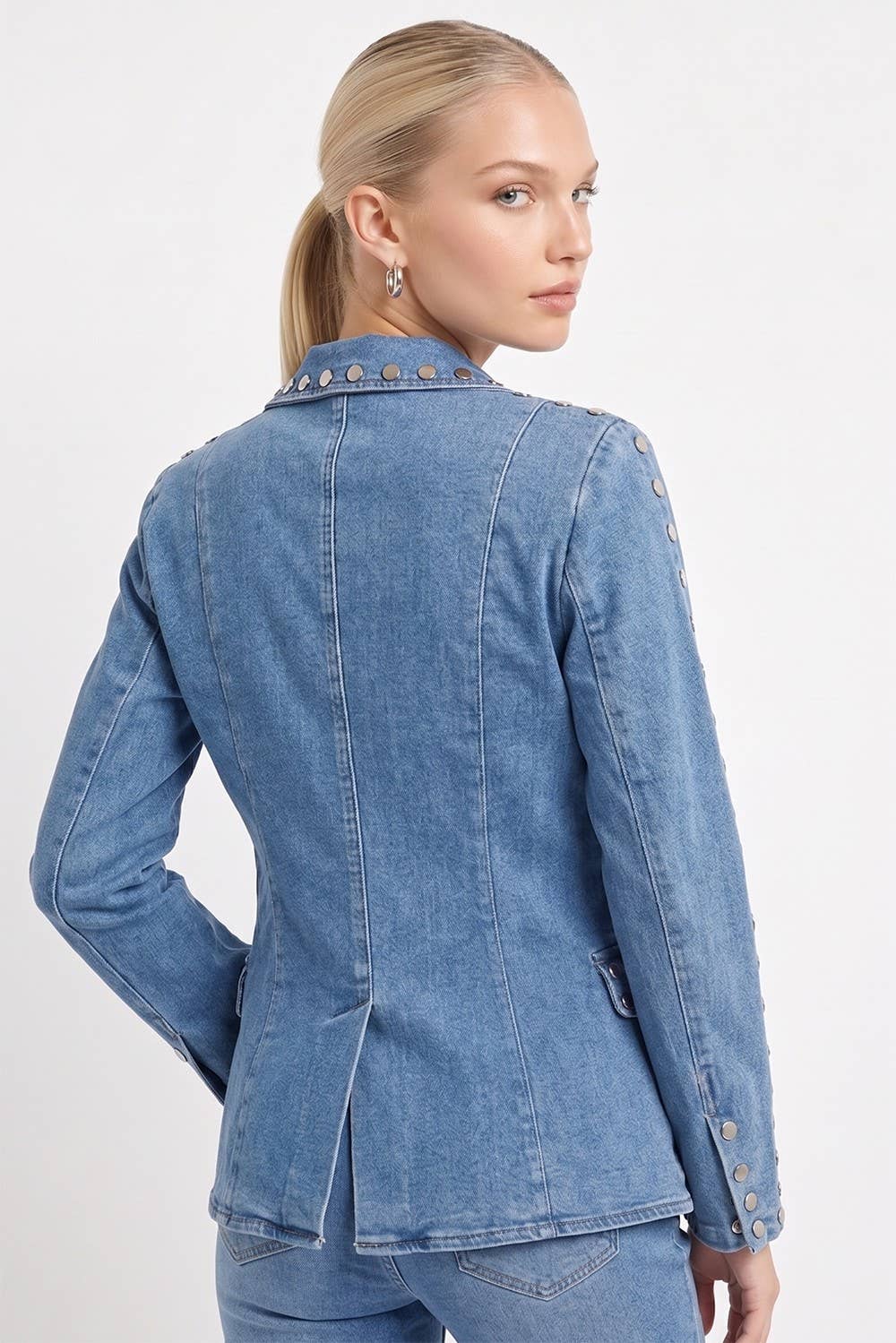Woman wearing a blue denim jacket on a white background