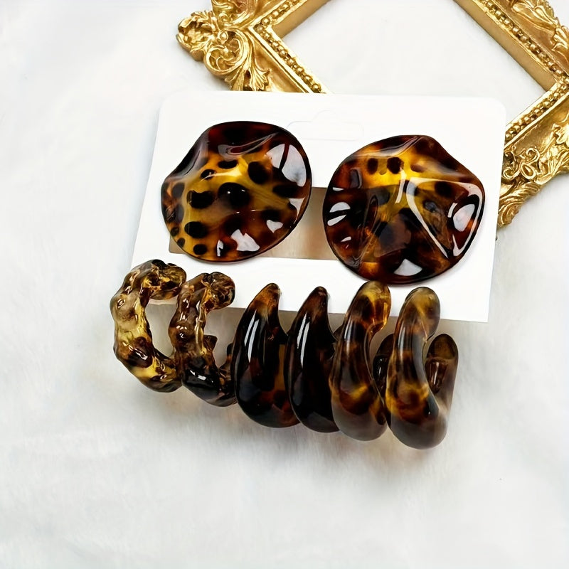 A bundle pair of round leopard print acrylic ear studs with a glossy finish and vintage style.