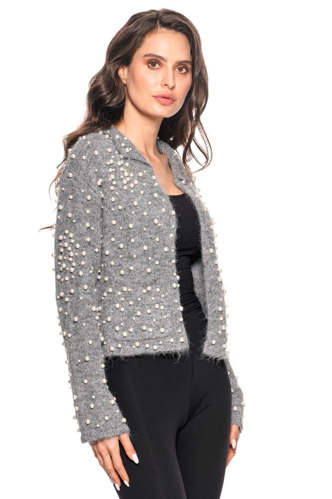 Woman wearing a gray embellished jacket on a white background