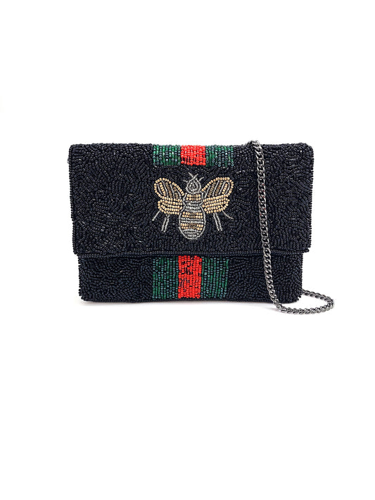 Black textured handbag with bee embroidery and colorful stripes on a white background