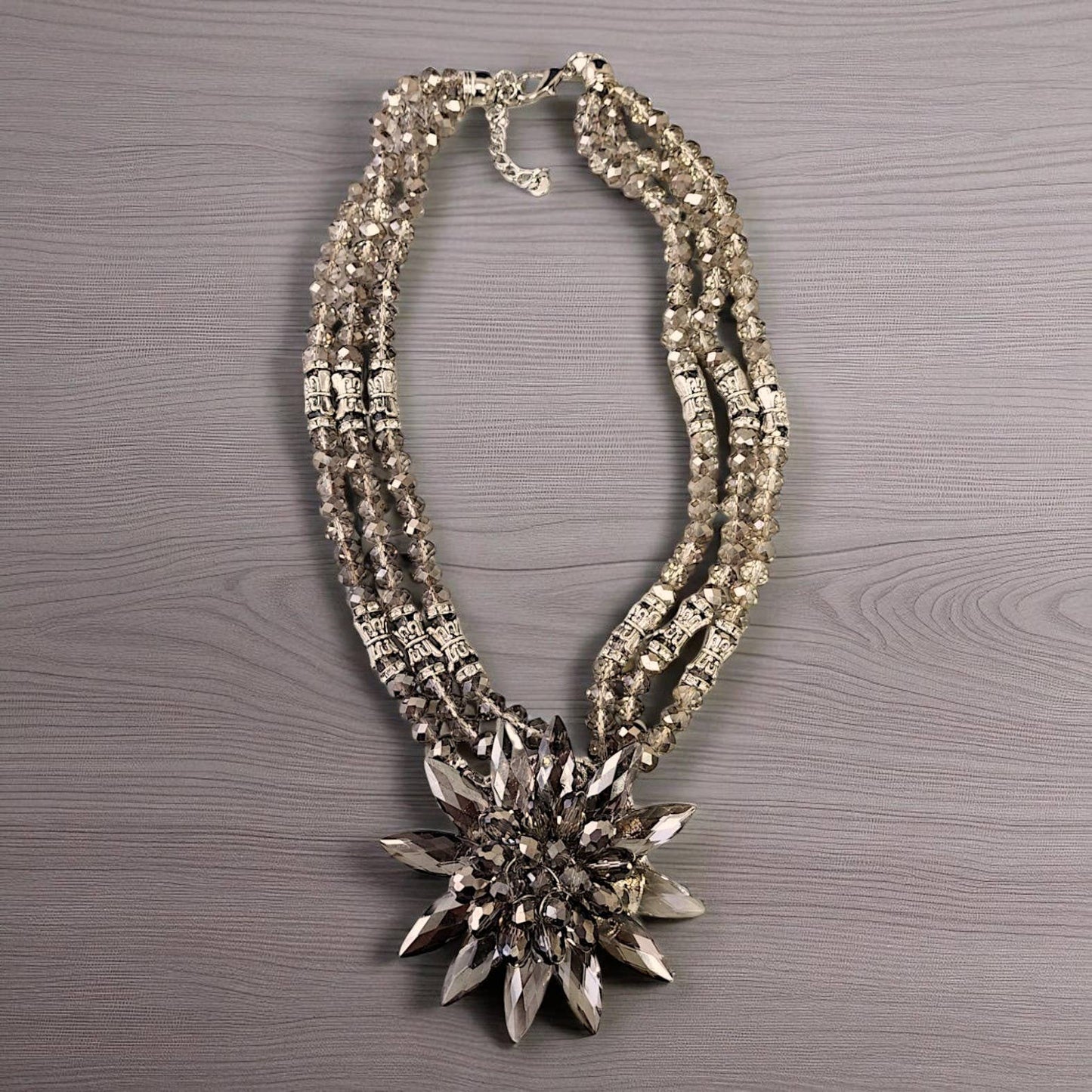 Decorative necklace with a star-shaped pendant on a wooden surface