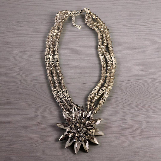 Decorative necklace with a star-shaped pendant on a wooden surface