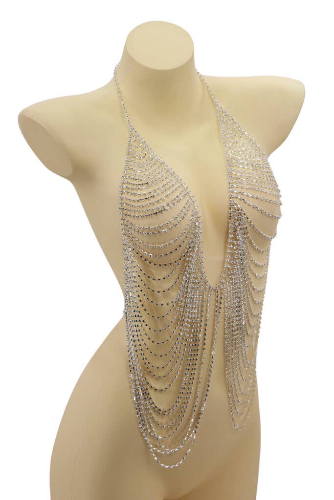 Mannequin wearing a sparkling silver halter top with chain details on a white background