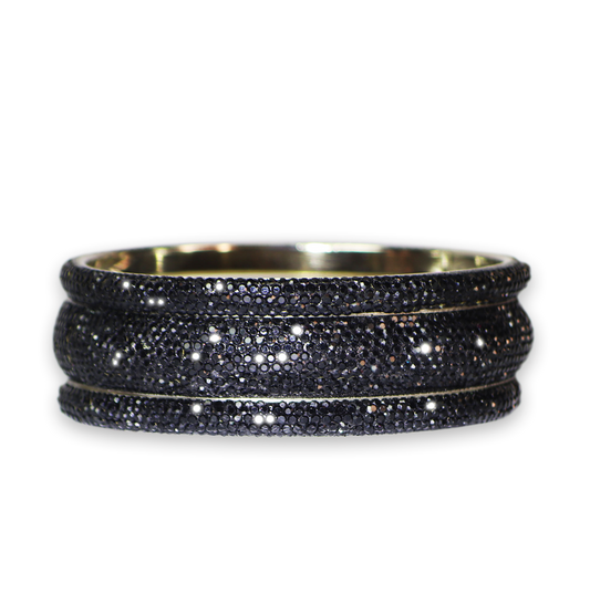 Set of black beaded bracelets on a white background