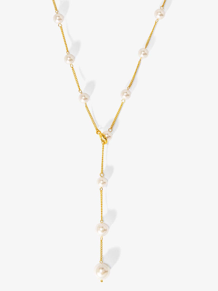 Gold necklace with pearls on a white background