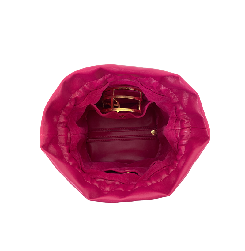 Pink handbag with gold interior on a white background
