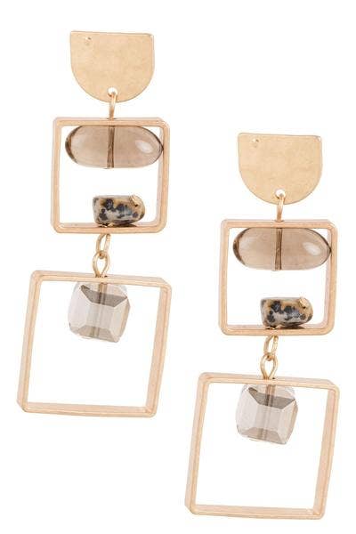 Gold-framed earrings with stone-like elements on a white background