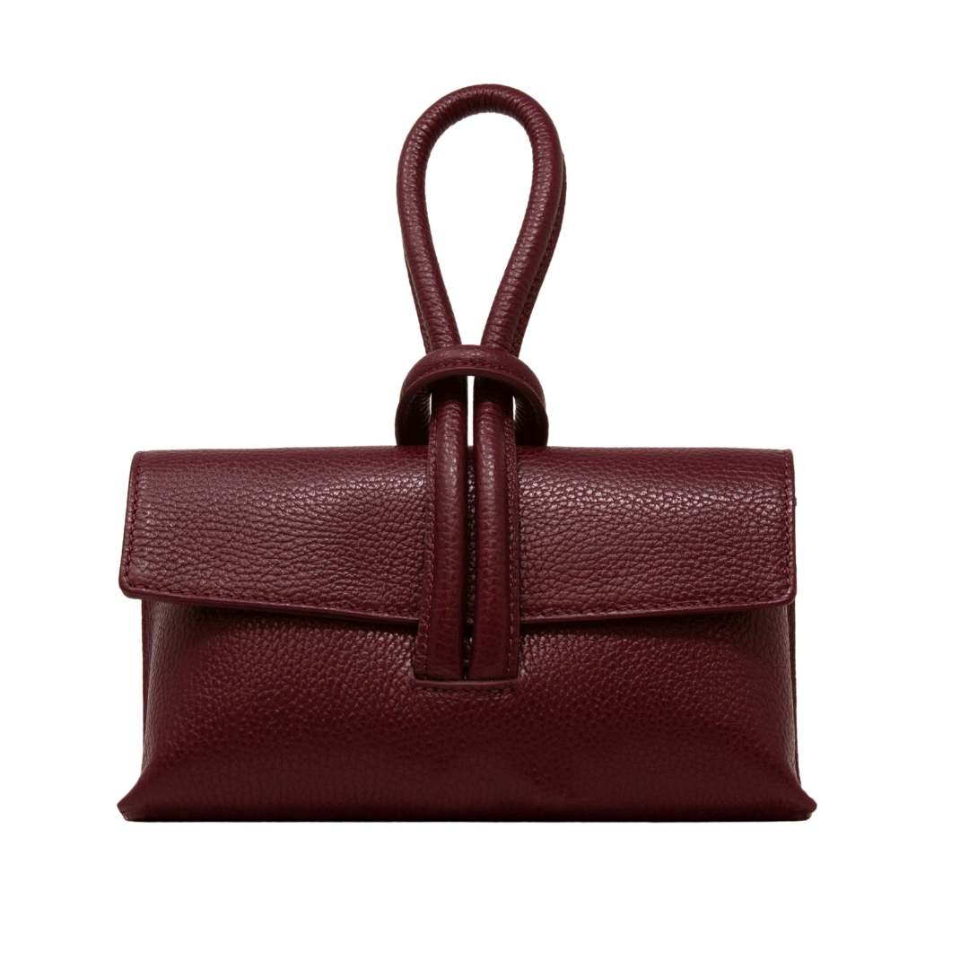 Brown leather handbag with a strap on a white background