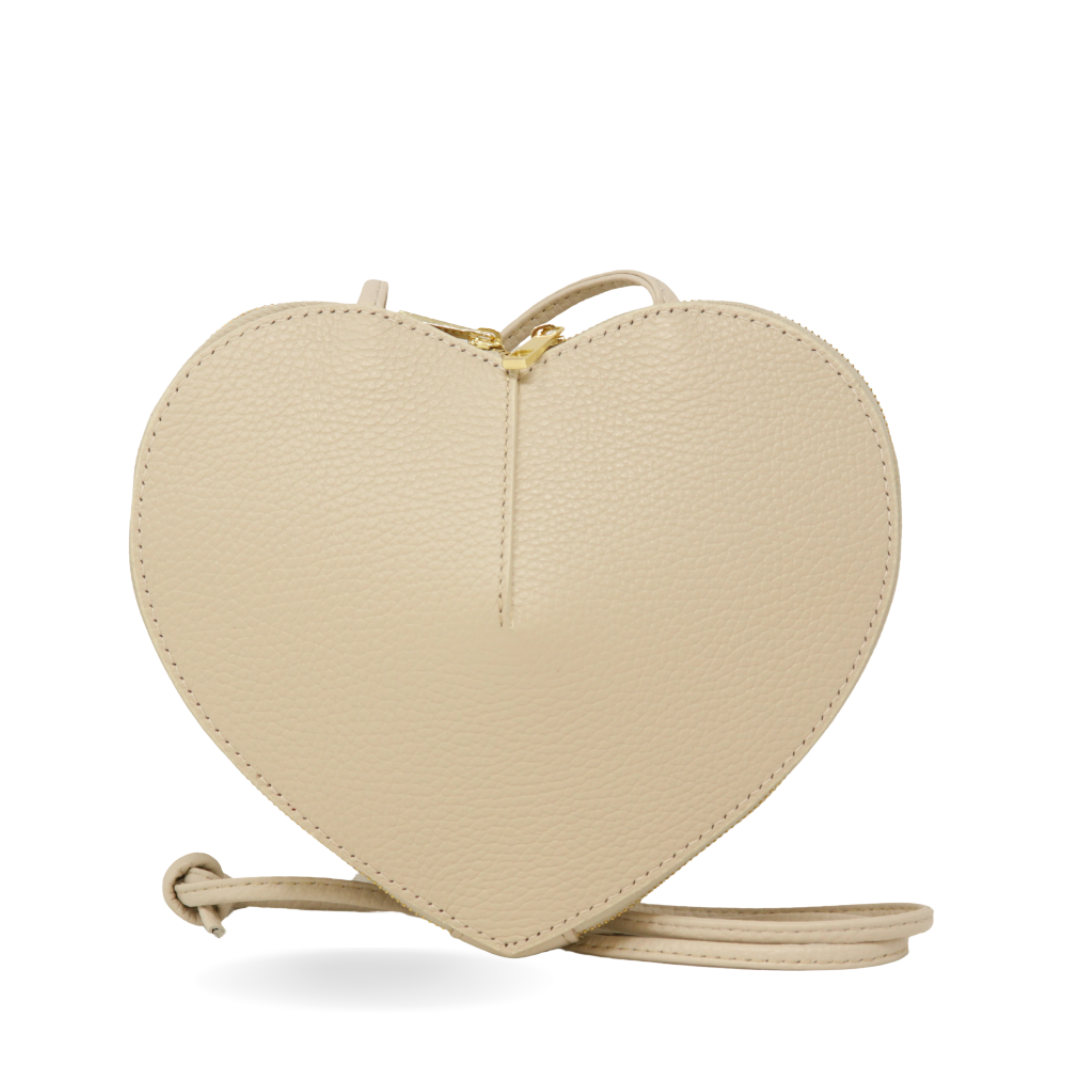 Beige heart-shaped bag with a strap on a white background