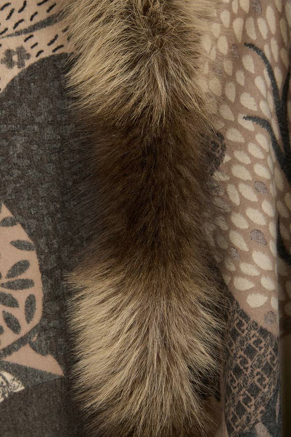 Close-up of a fluffy brown tail against a patterned background