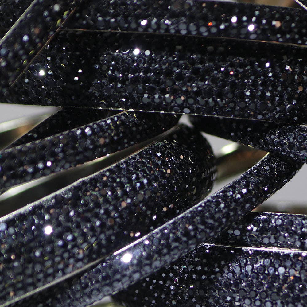 Close-up of black glittery ribbons stacked together