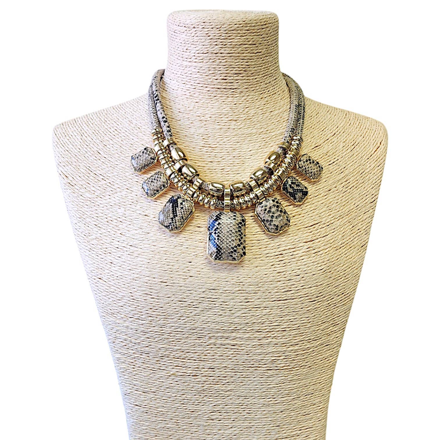 Necklace with large beads on a mannequin bust against a white background