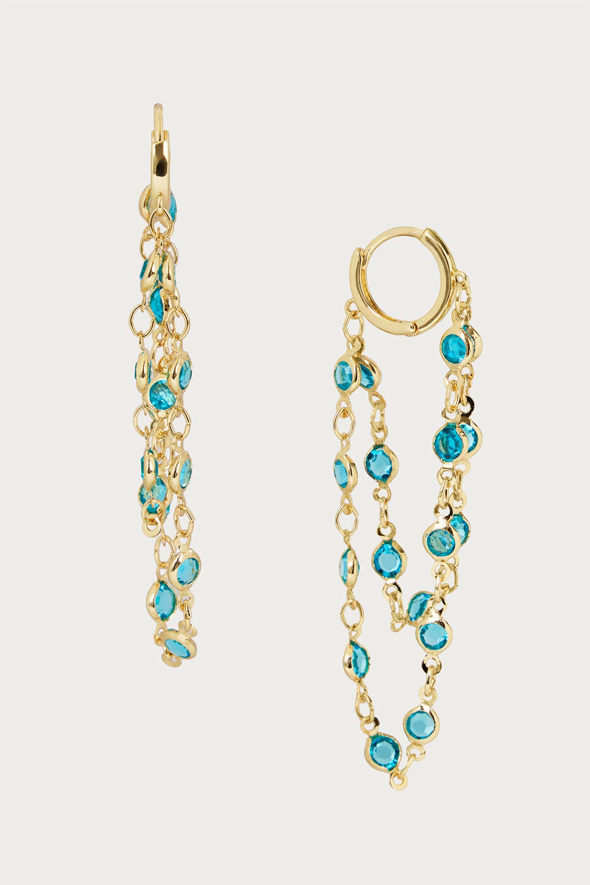 Gold earrings with turquoise stones on a white background