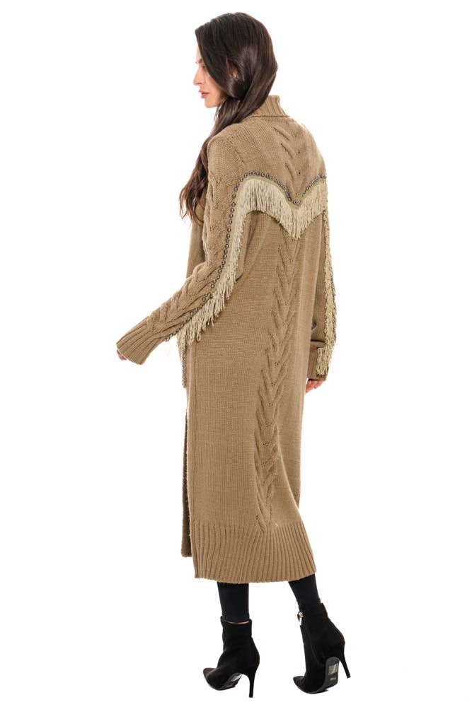 Woman wearing a long beige cardigan with fringe details on a white background