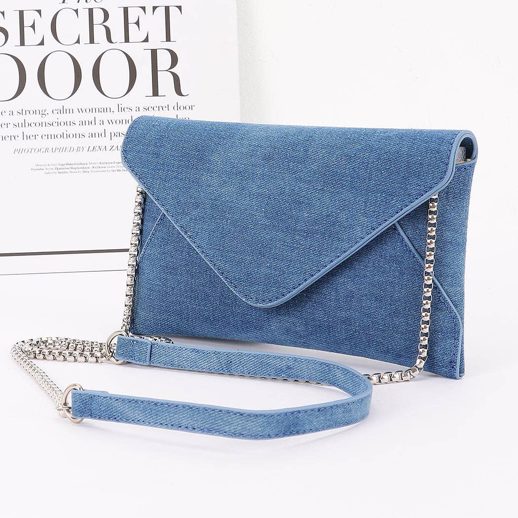 Blue denim clutch bag with chain strap on a white background