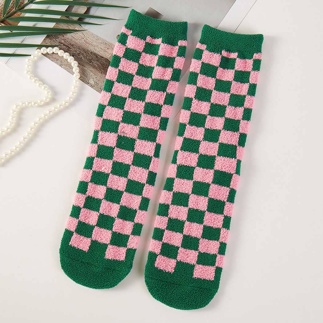 Green and pink checkered socks on a light background