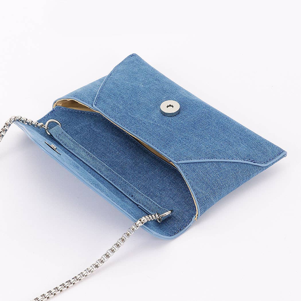 Blue denim clutch bag with a chain strap on a white background