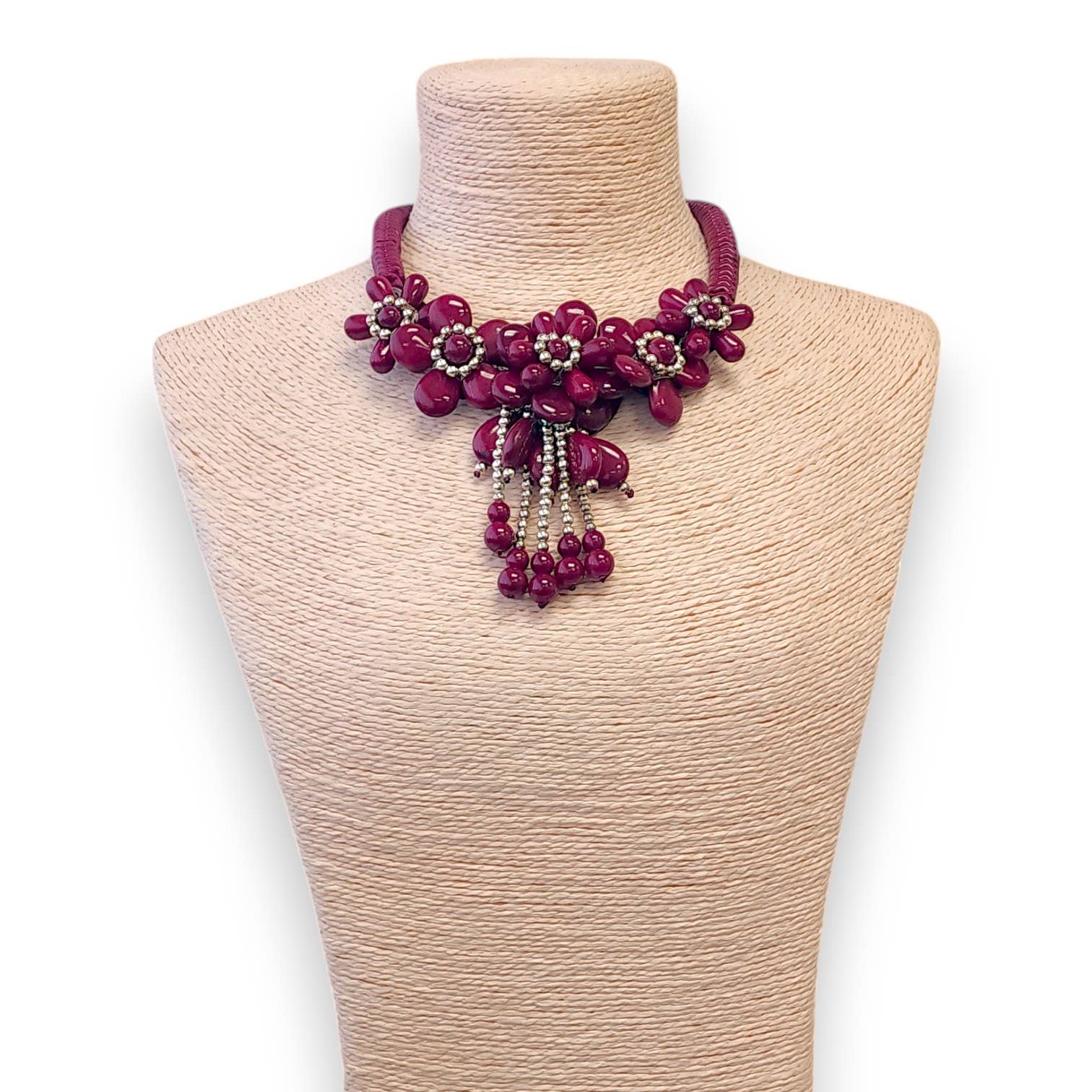 Necklace with pink beads on a mannequin bust against a white background