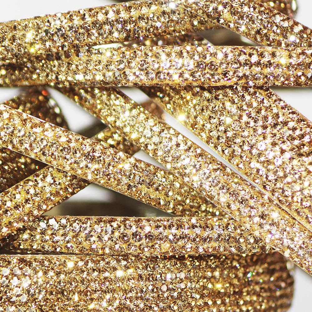Close-up of gold glittery ribbons on a white background