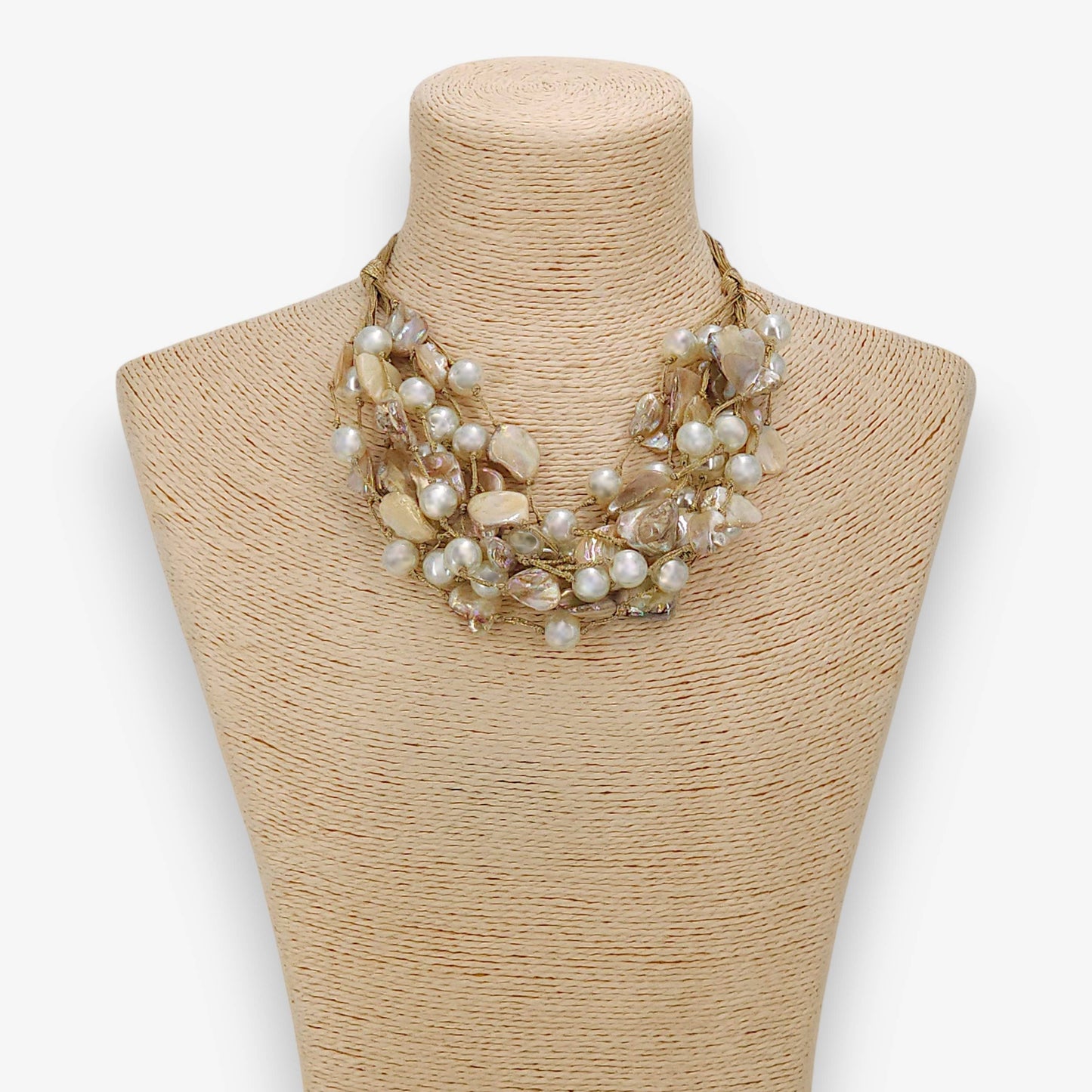 Necklace on a mannequin bust with a plain background