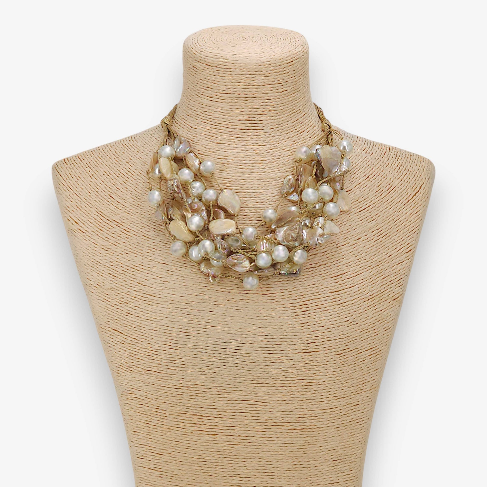 Necklace on a mannequin bust with a plain background