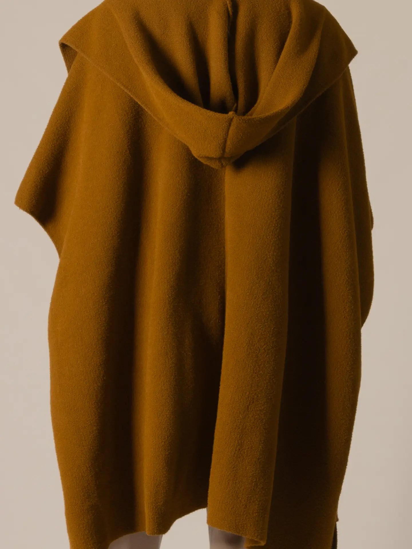 Brown hooded garment on a plain background