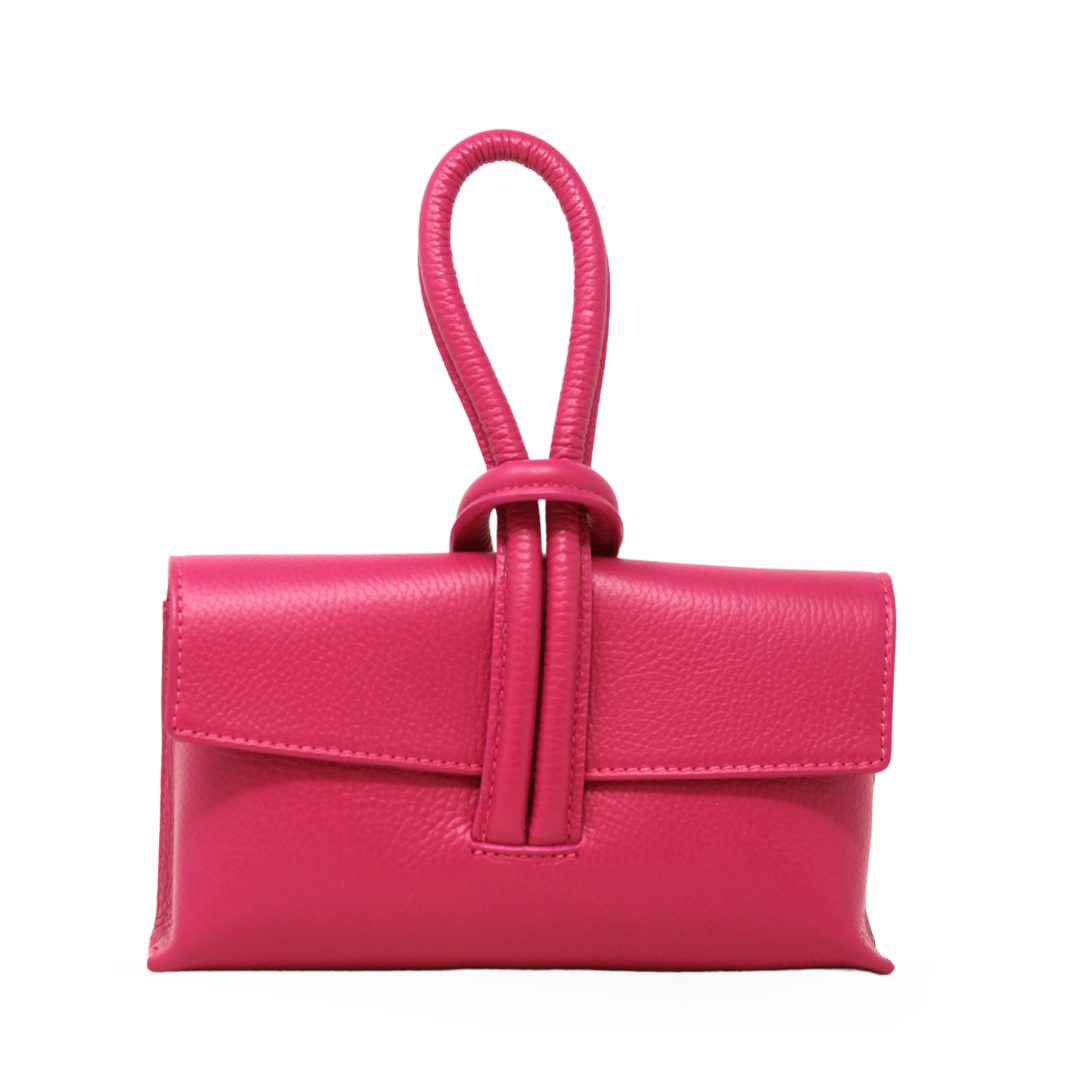 Pink leather handbag with a strap on a white background