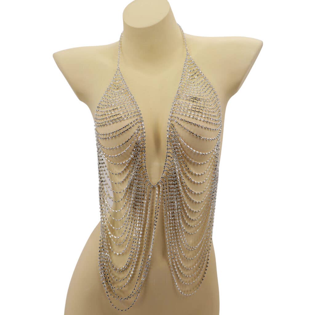 Mannequin wearing a sparkling, chain-like garment on a white background