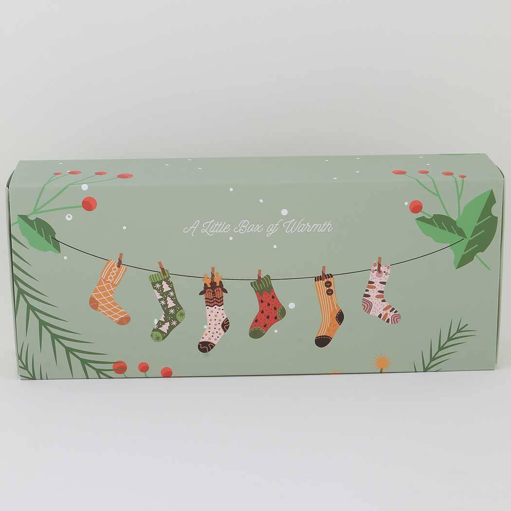 Box with illustrations of Christmas stockings and text on a light green background