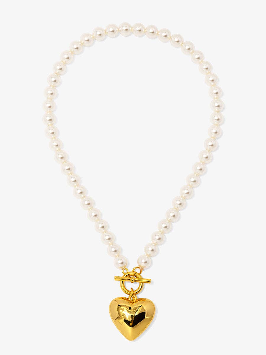 Pearl necklace with a gold heart-shaped clasp on a white background