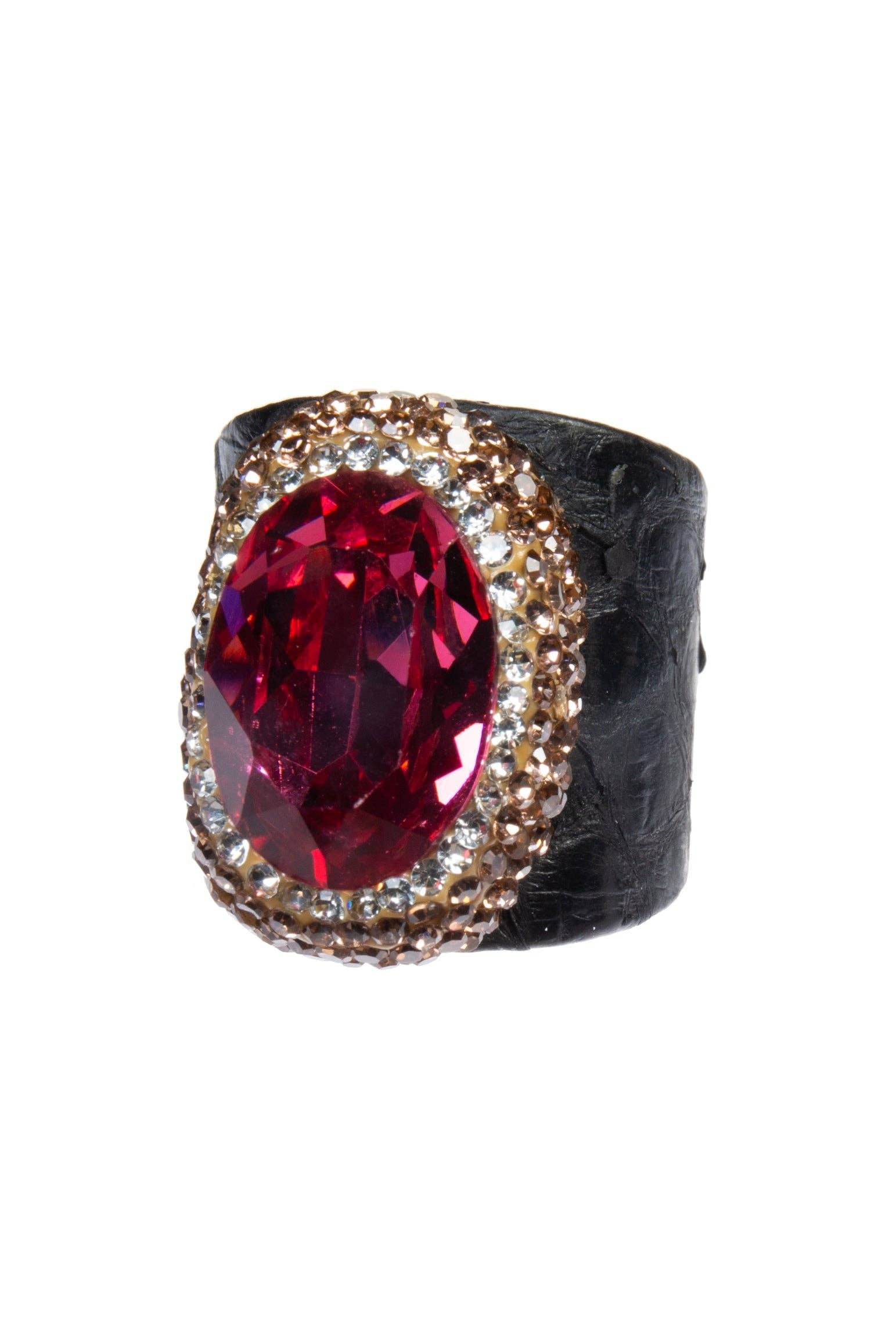 Ring with a red gemstone and gold accents on a white background
