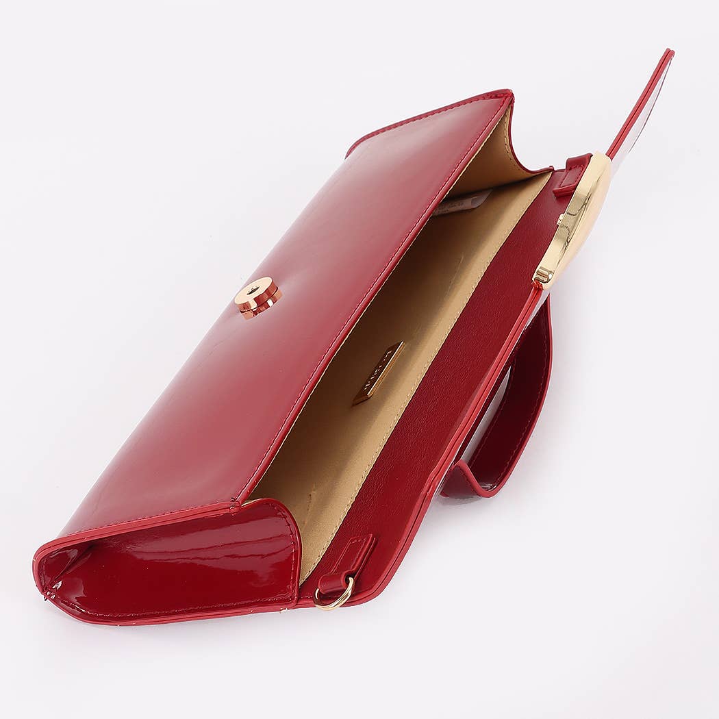 Red handbag with gold accents on a white background