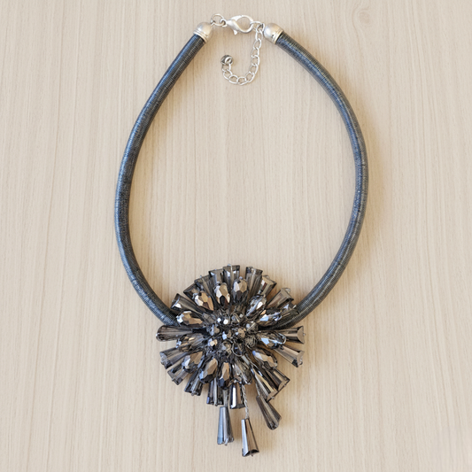 Necklace with a decorative pendant on a wooden surface