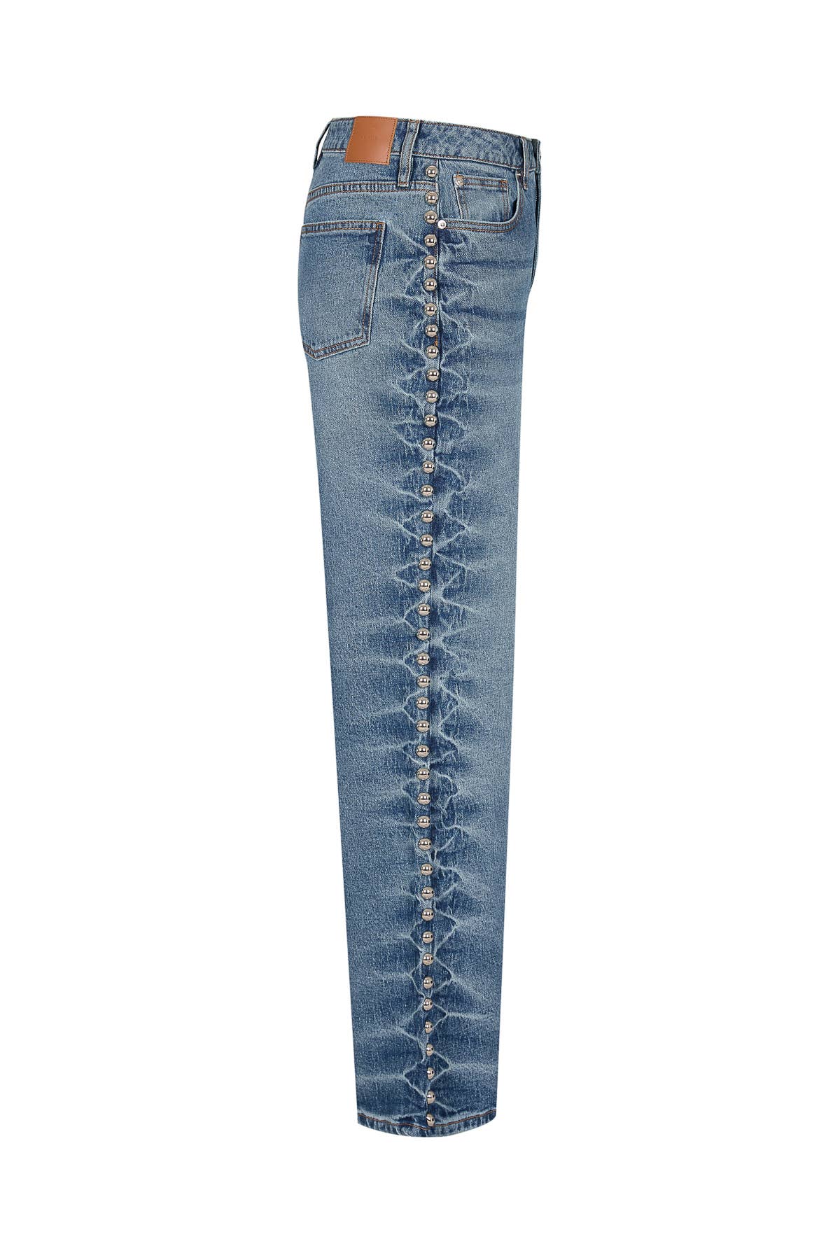 Blue jeans with decorative button details on a white background