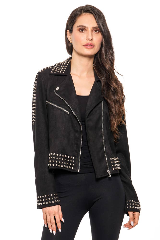 Woman wearing a black studded jacket on a white background