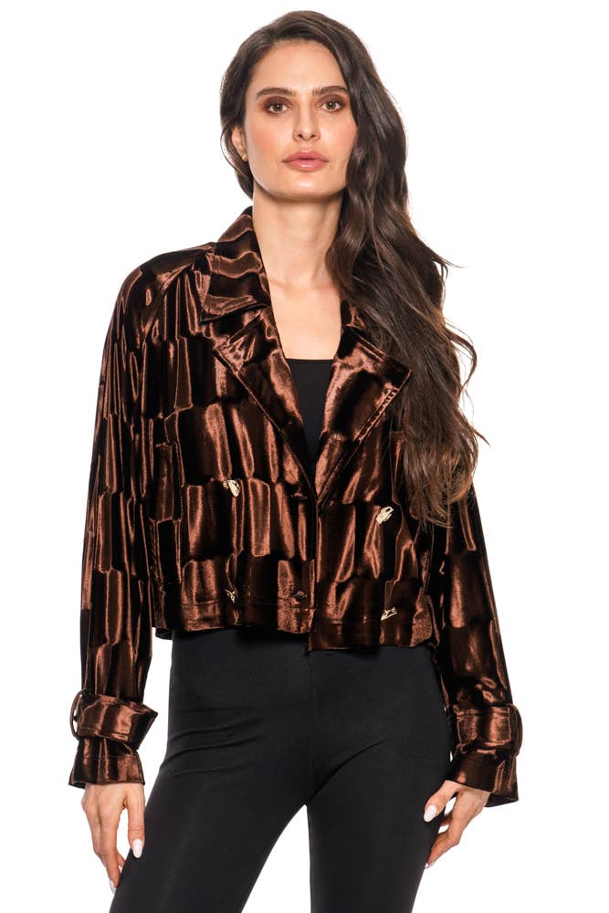 Woman wearing a metallic brown jacket on a white background