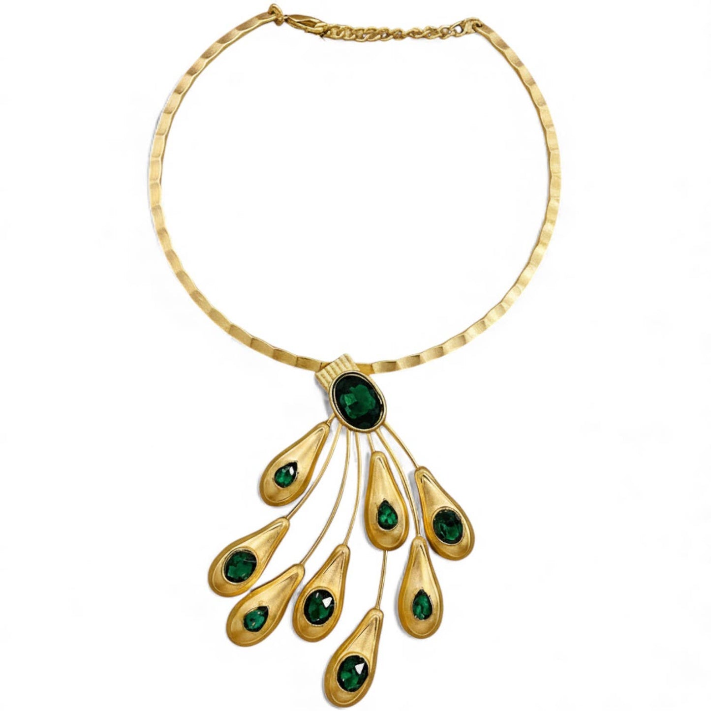 Gold necklace with green gemstones on a white background