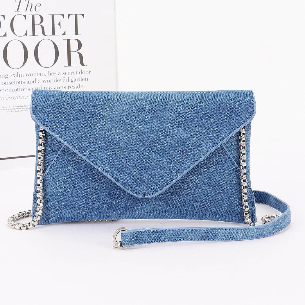 Blue denim handbag with chain detail on a white background