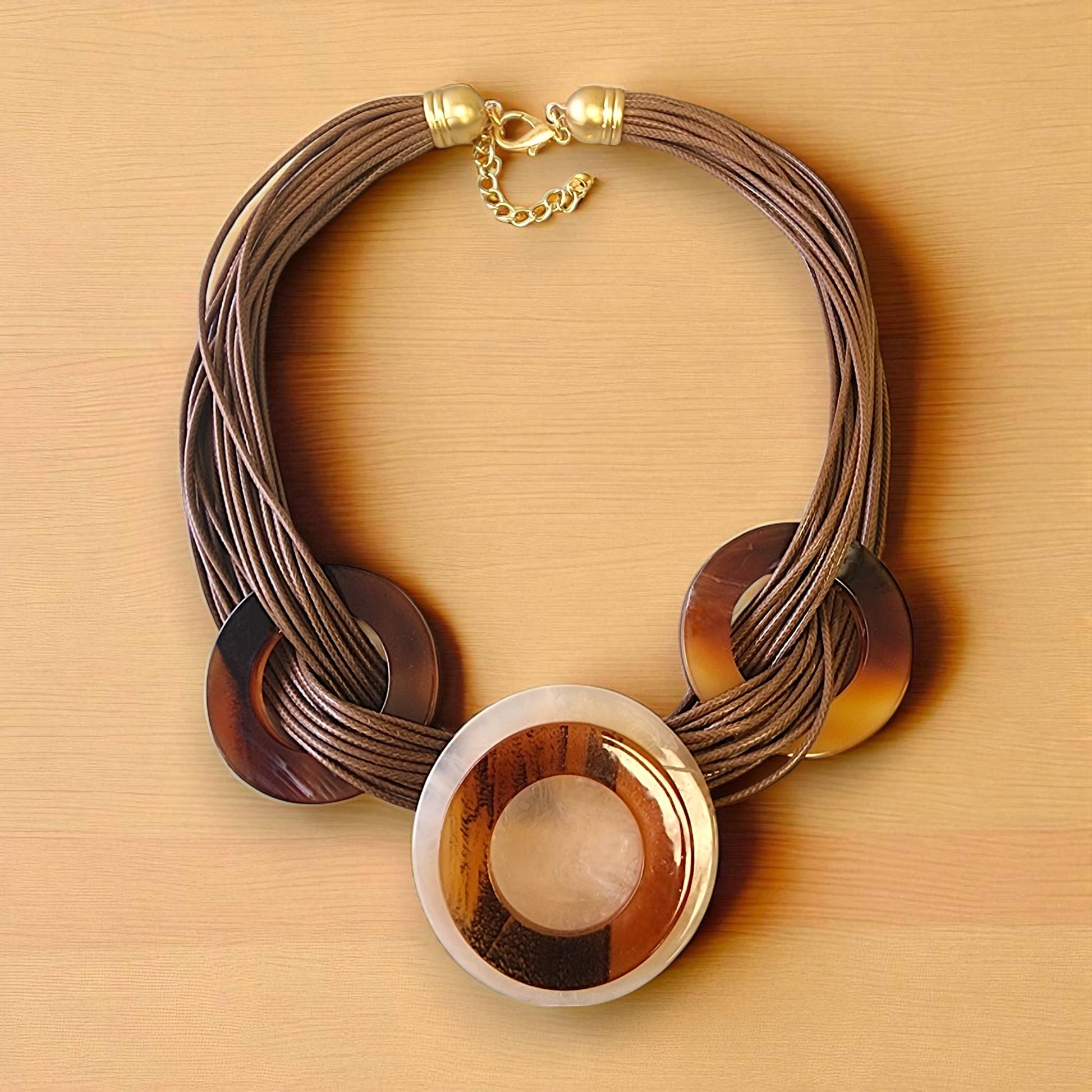 Necklace with circular wooden pendants on a beige background