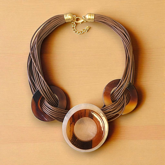 Necklace with circular wooden pendants on a beige background