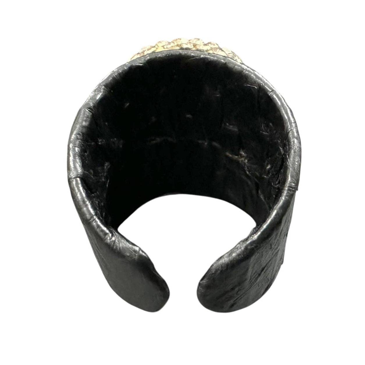 Black metal ring with a textured surface on a white background