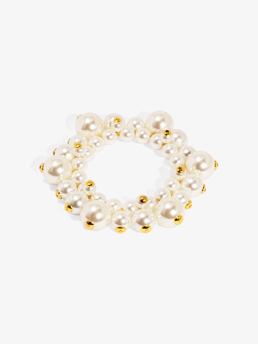 Pearl bracelet with gold accents on a white background